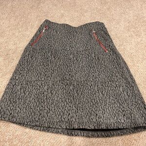 Gray and black mid thigh skirt with red zipper detail